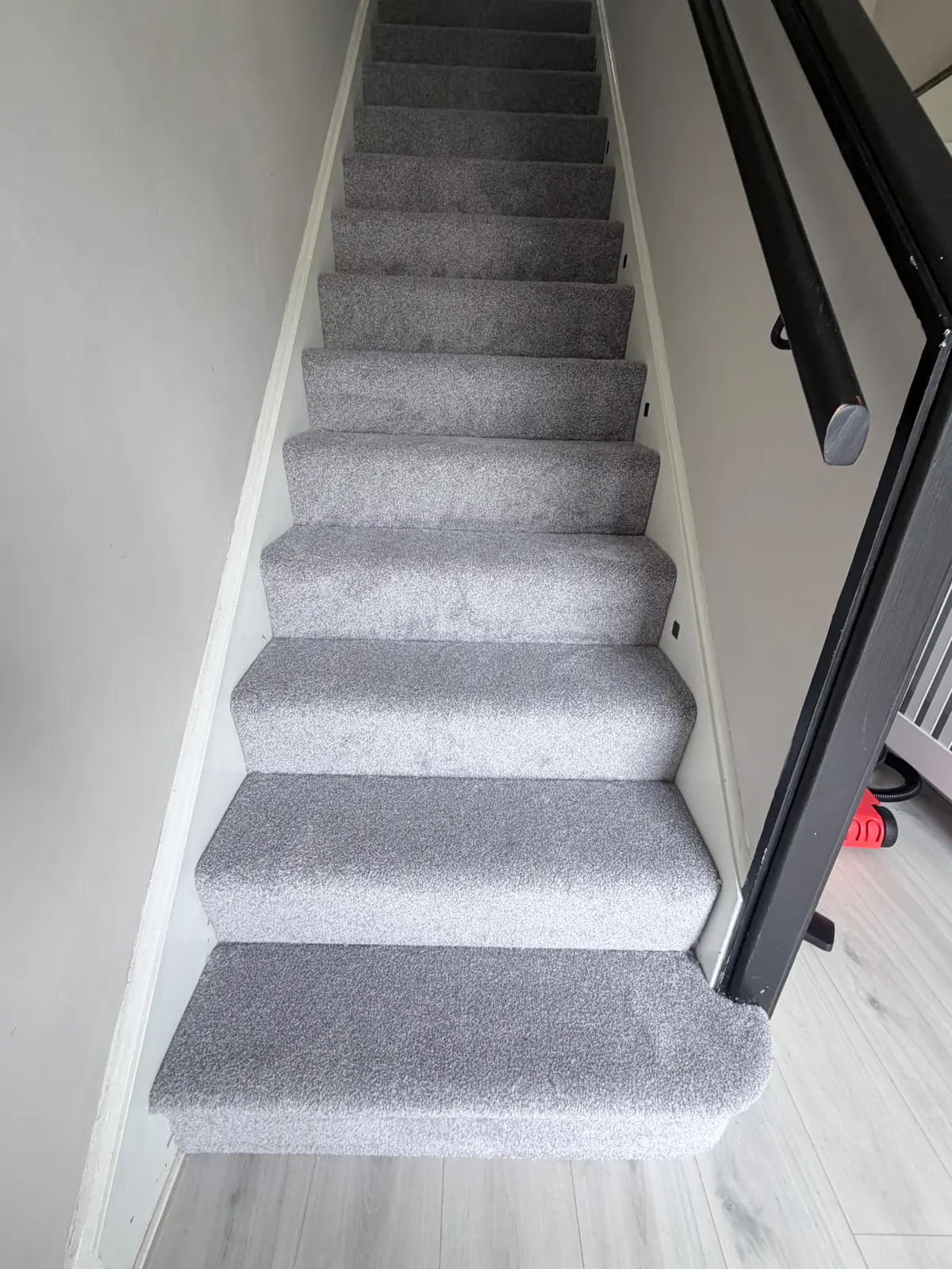 Stair carpet meeting the hallway floor in a Darlington home