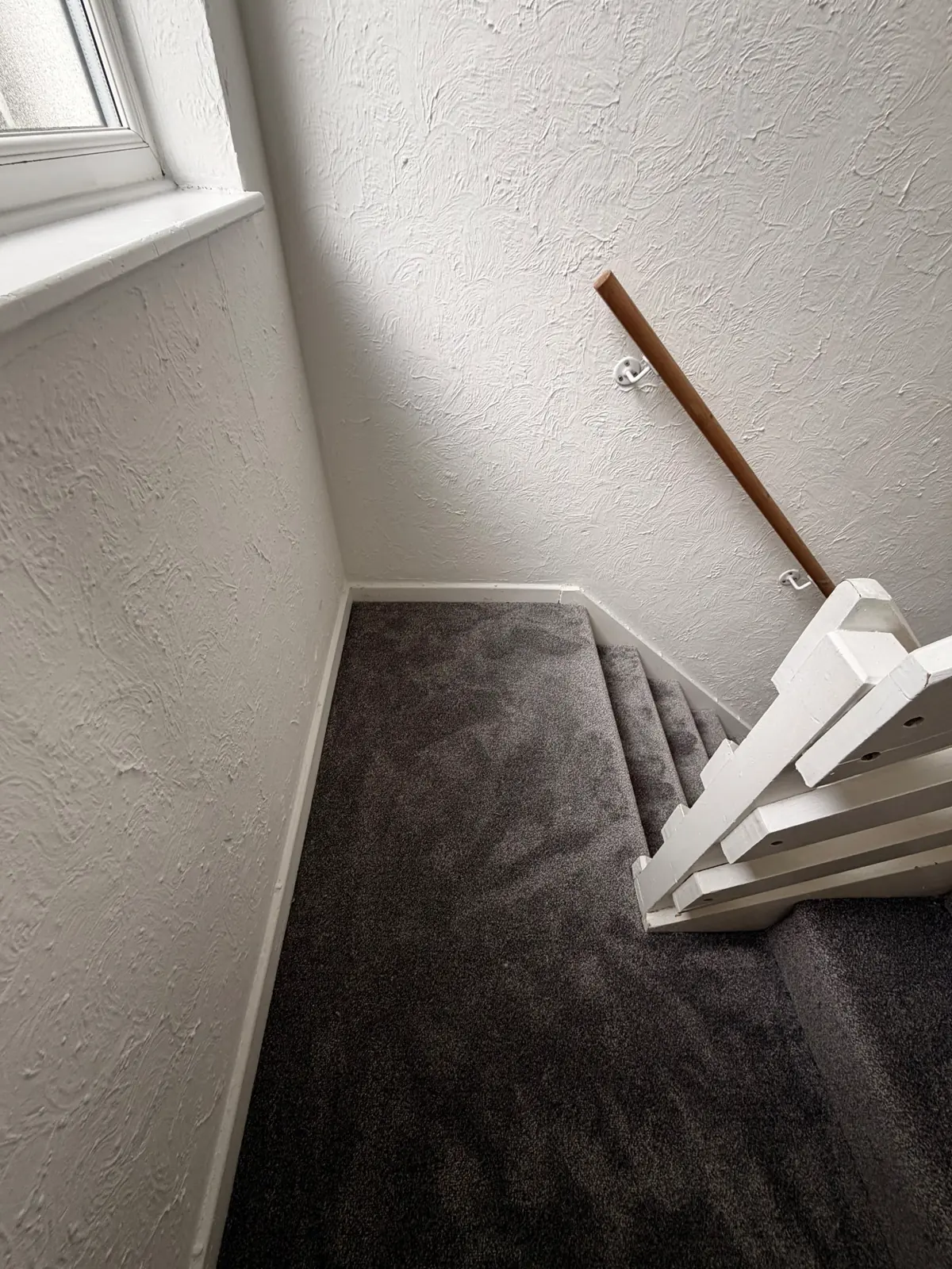 Carpet wrapped around winder steps on a Newton Aycliffe staircase