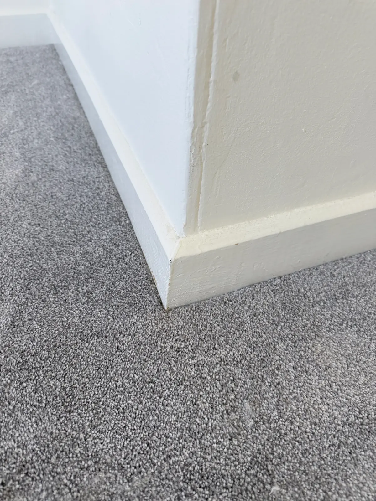 Close-up of a carpet edge trimmed tight to the skirting board in Darlington