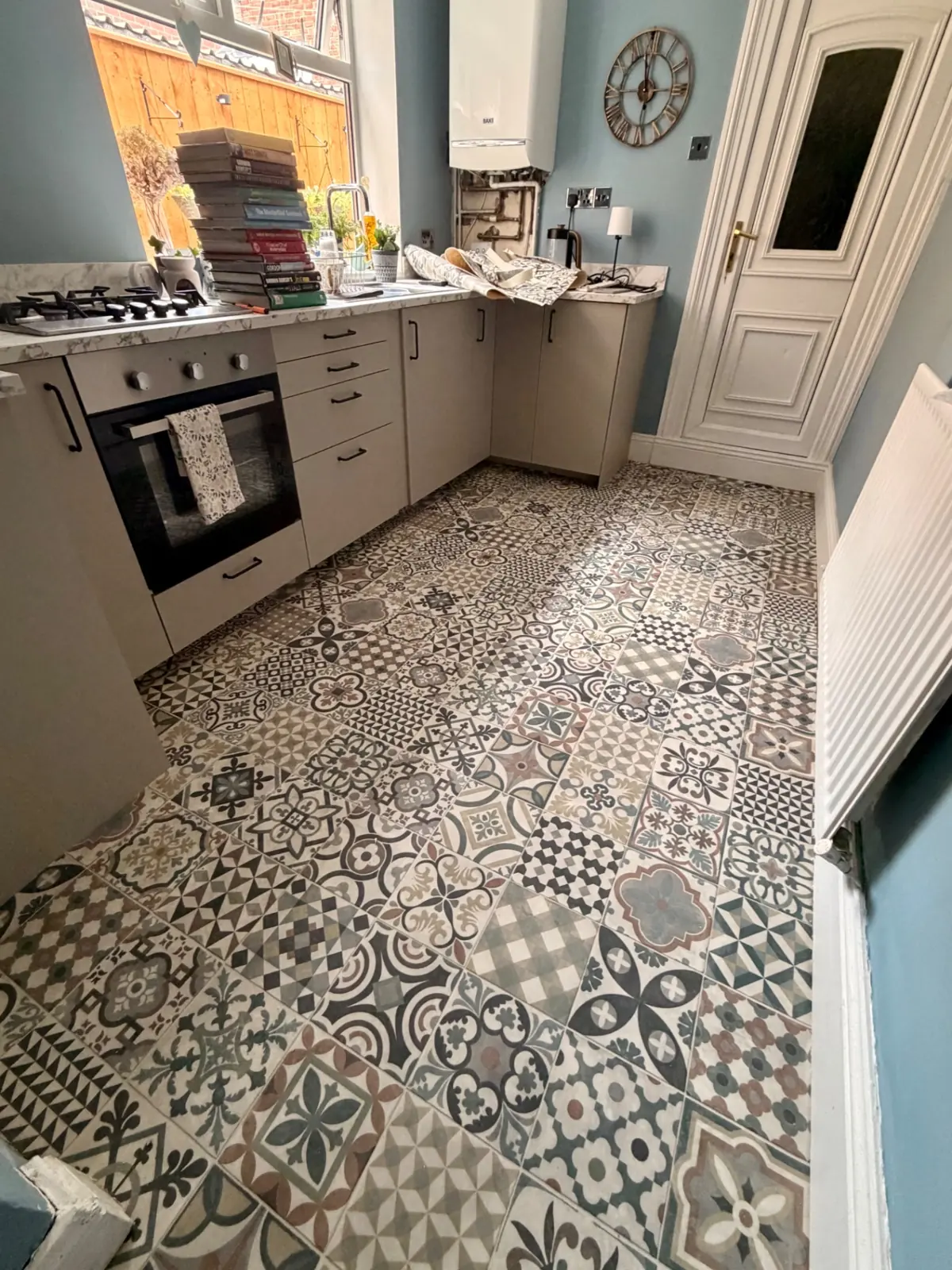 Patterned vinyl flooring cut in around kitchen units in Bishop Auckland